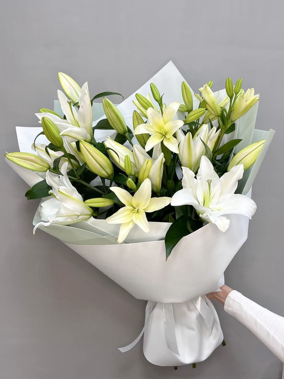 Generous bouquet of 7-stemmed white lilies, elegantly packaged